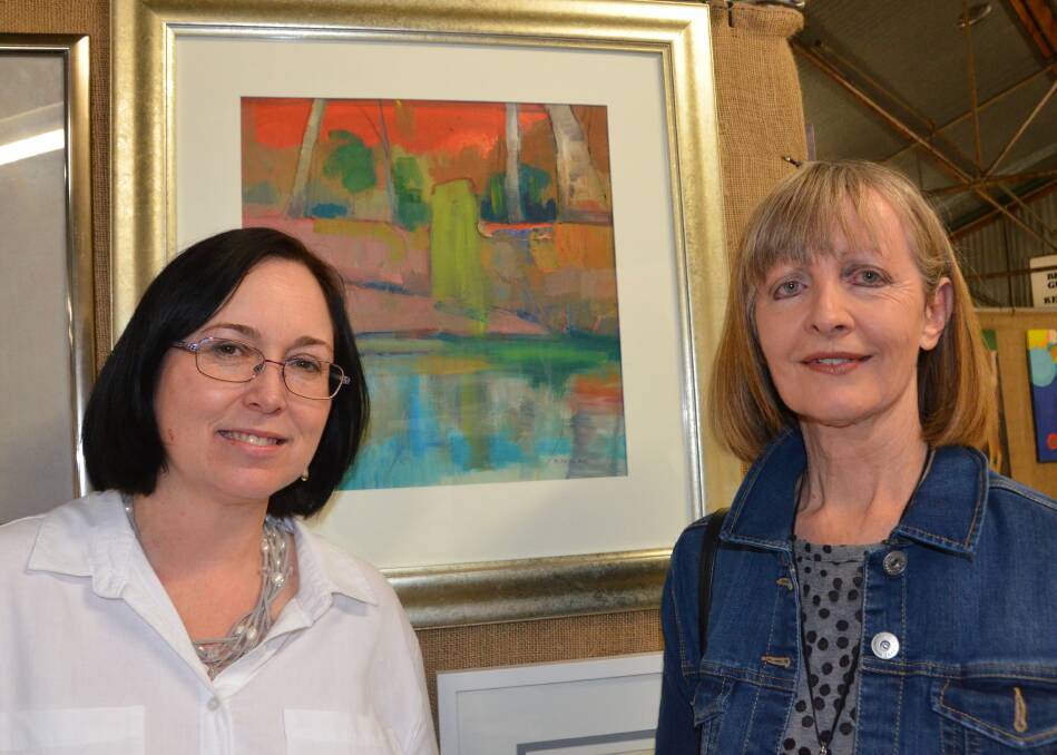 ART PRIZE: Local artist Maree Kelly and former Gunnedah artist Yvette Hugill at a previous art prize and exhibition at the Gunnedah Show opening night.