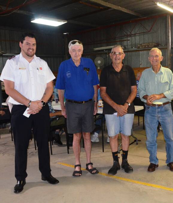 GIFT OF GIVING: Salvation Army Captain Richard Day, left and St Vincent de Paul's Vince Tydd, right, receive donations from Gunnedah Rural Museum representatives Terry Egan and Jim Noon for their Christmas appeals.