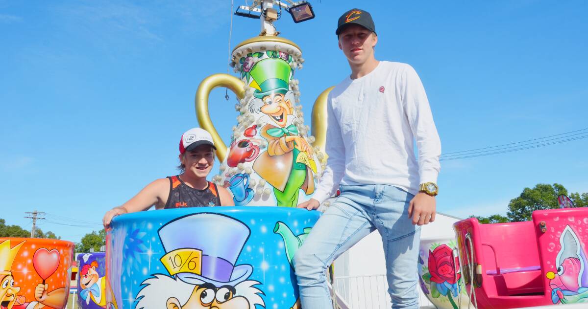 CARNIVAL FUN: Cody and Coby Brown, of Dubbo and Alice Springs, are setting up tea cups and dodgem cars at the showground ready for this weekend's Gunnedah Show.
