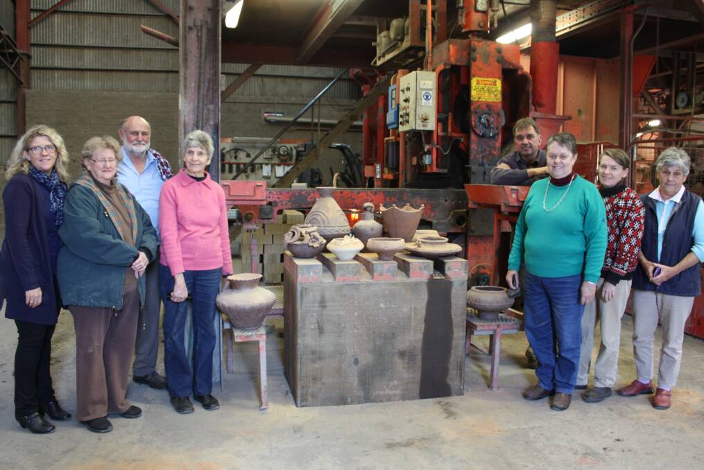 JOMON POTTERY: Jenni Carlin, Anne Pickett, Rick Thomas, Pat Tobin, Michael Broekman, Louise Baker, Martine Moran and Annie Simson with their ceramics which were removed from the kiln at Gunnedah Brickworks on Monday.