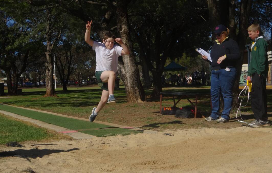 FLYING HIGH: Mathew Adams flies through the air during long jump at the Gunnedah Public School athletics carnival on Monday. The carnival was held at Wolseley Oval.