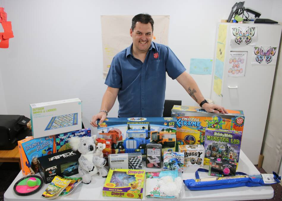 Gunnedah Salvos are calling for donations of gifts to help local families prepare for Christmas. Pictured is captain Richard Day with some of the gifts already donated. Photo: Vanessa Höhnke