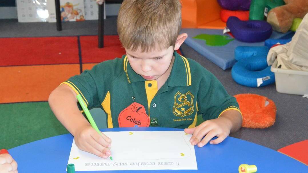 Caleb Brown concentrates on writing in Kindergarten class at Gunnedah Public School.