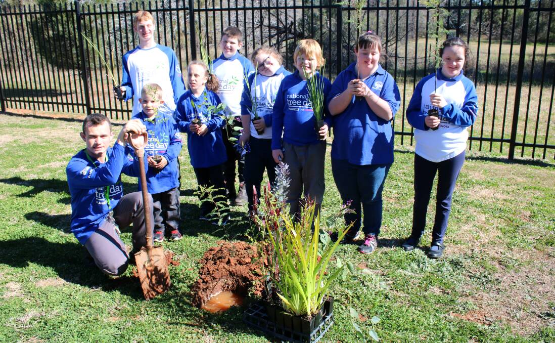 HANDS ON LEARNING: GS Kidd Memorial School students ready to plant native trees along the boundary line of the grounds for Schools Tree Day.