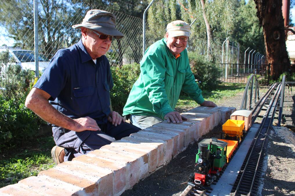 Gunnedah Rural Museum members Bill Barry and Owen Tydd put the miniature trains rthrouhg their paces in the new exhibit.