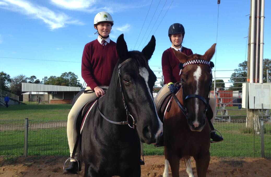 Pony Club members Jess McKechnie and Lara Bullen on their horses at the Narrabri Blanch Trophy Day.