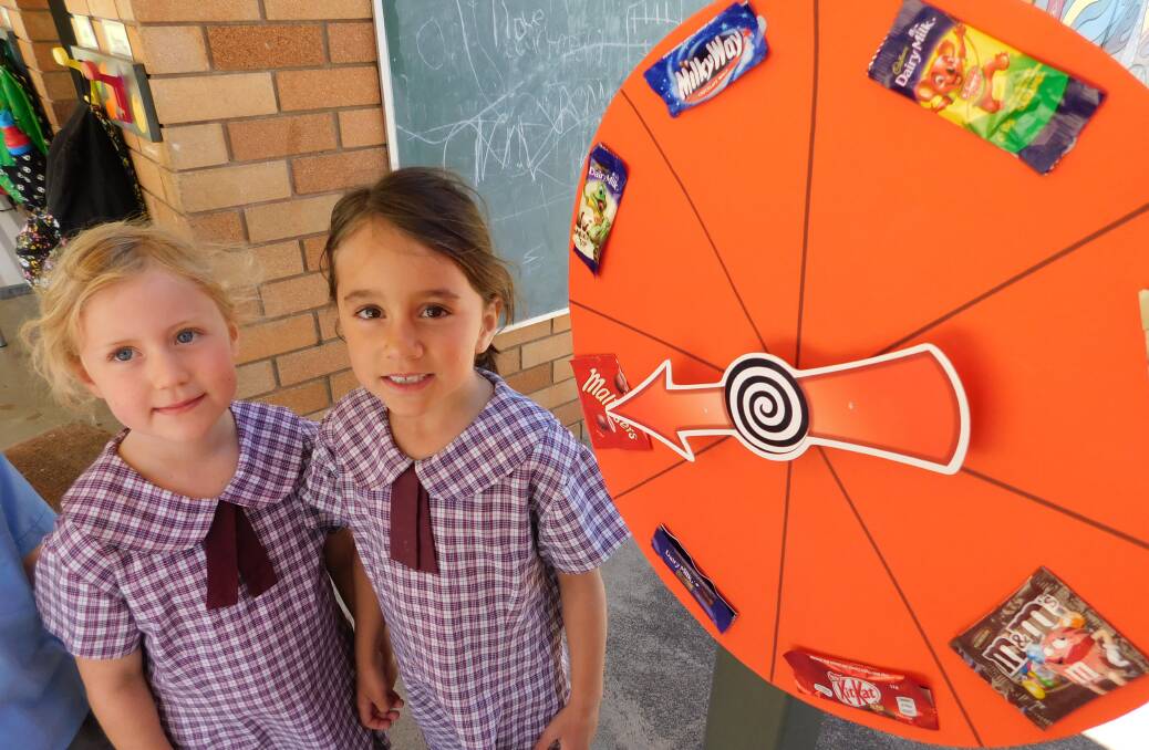 Hannah Mackellar and Brenna Pearce with a chocolate wheel during Catholic Missions Week at St Xavier's Primary School.