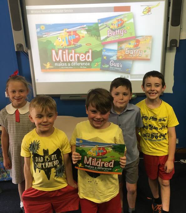 Harriet Snow, Ryan Bazjath, Tyler Howed, Sunny Wicks and Clinton Hall enjoy Mildred the Westpac Helicoptor book at Gunnedah South Public School.