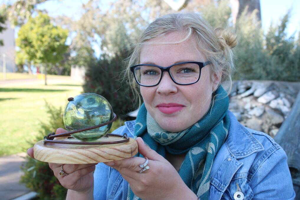 WORLD OF POETRY: Dorothea Mackellar Poetry Awards project officer, Ruth Macaulay, with one of the unique trophies created by artist Alison Dent.