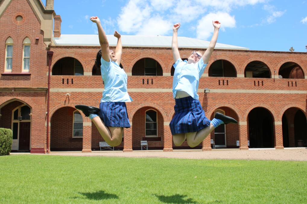 LEAPING FOR JOY: St Mary's students Maria Ortiz and Leah Broekman are thrilled to be free of the Higher School Certificate.
