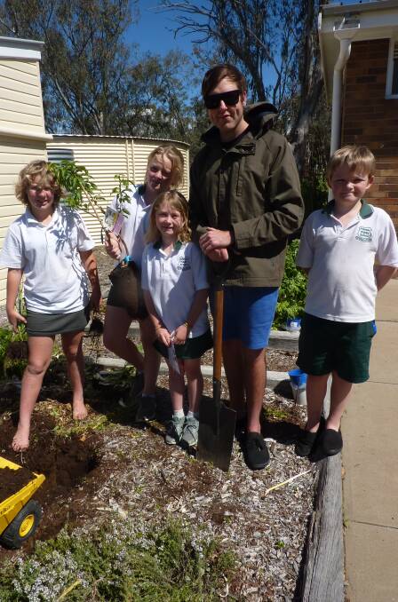 Penny Morley, Lydia Aulton, teacher Jacob Easey, Riley Collins and Parker Collins ready to plant fruit salad trees in the garden at Premer Public School.