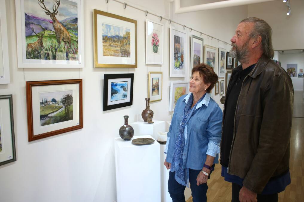 Judges Barbara Dolahenty (ceramics) and Rowen Matthews (art) view the exhibition works on Thursday ahead of the opening.