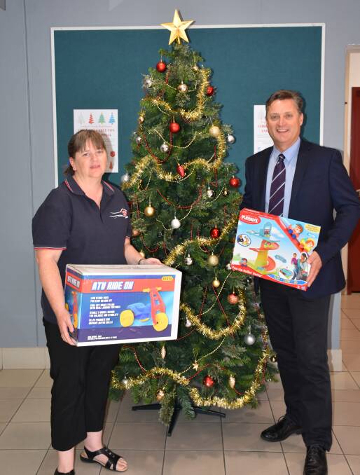 Gunnedah Salvation Army's Dianne Schutz and Gunnedah Shire mayor Jamie Chaffey with one of the Christmas trees at the council. Photo: Supplied