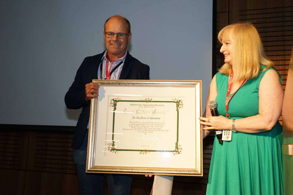 Tim Duffy accepts the Josef Lederer Award for Excellence in Optometry from Christine Craigie.