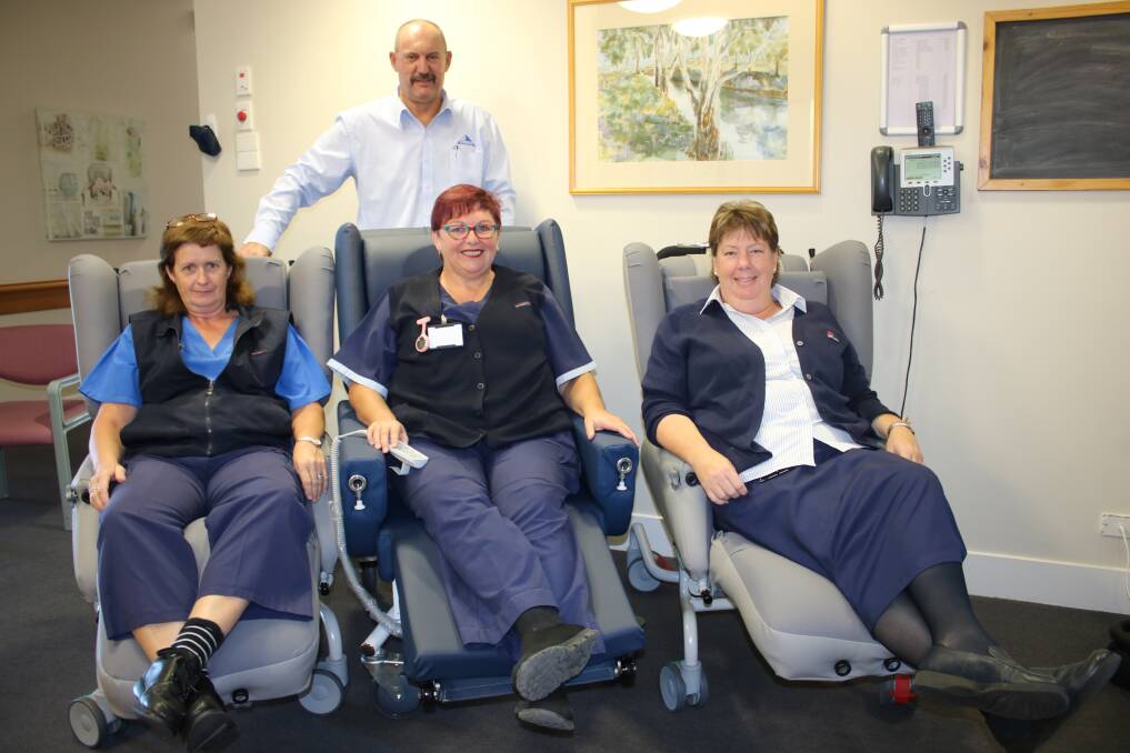 LAP OF LUXURY: Michelle Longworth, Donna Boyer and Liz Worboys try out the new pressure relief chairs at Boggabri Multipurpose Centre with Maules Creek Coal's Darren Swain.