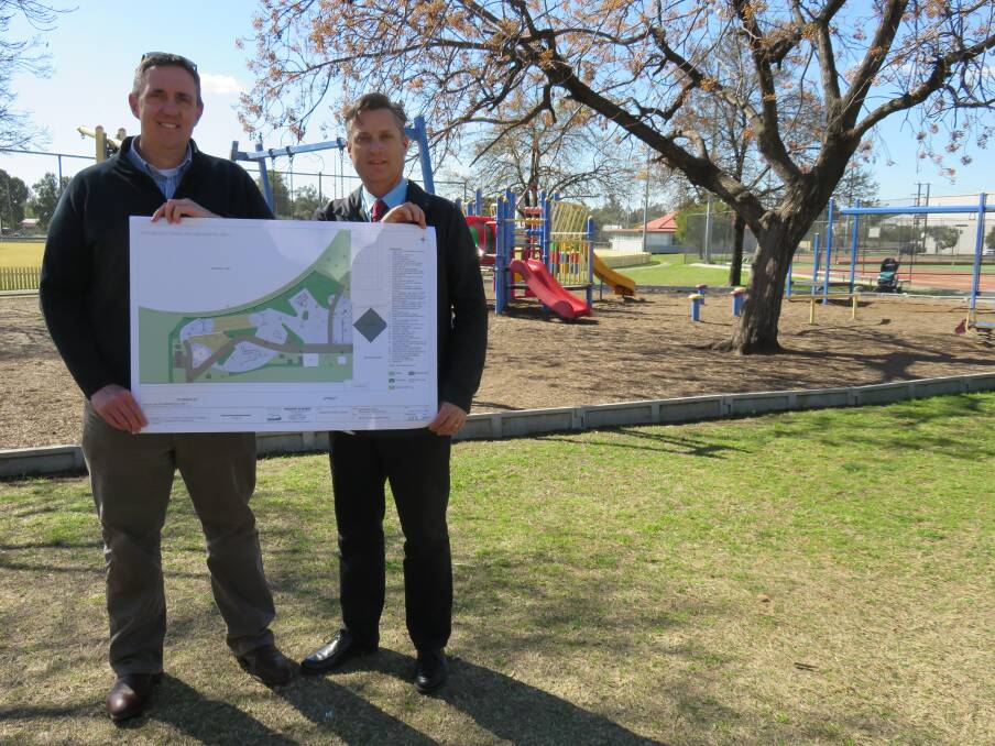 FORGING AHEAD: Gunnedah Shire Council's Andrew Johns and mayor Jamie Chaffey with the concept plan for the all-inclusive playground at Wolseley Park.