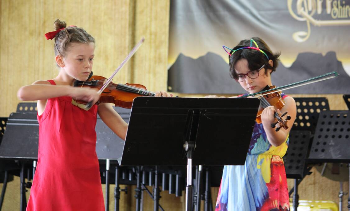 MUSICAL DUO: Olivia Osland and Rose Fairhall play Grandfather’s Clock in the instrumental section of the Gunnedah Eisteddfod last year.