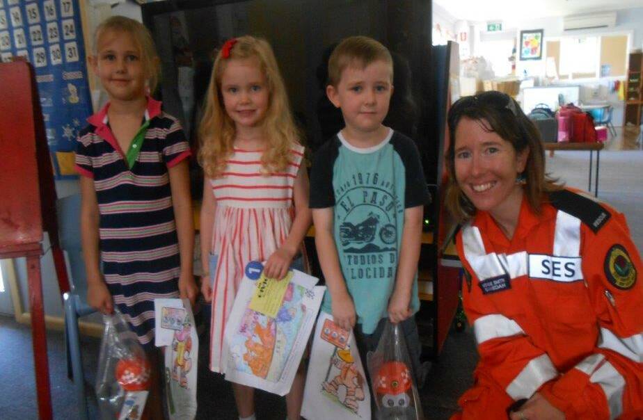 SES colouring competition winners Addison Hathway, Ruby Cygan and Sean Gander with Amelia Smith at the Baptist preschool.
