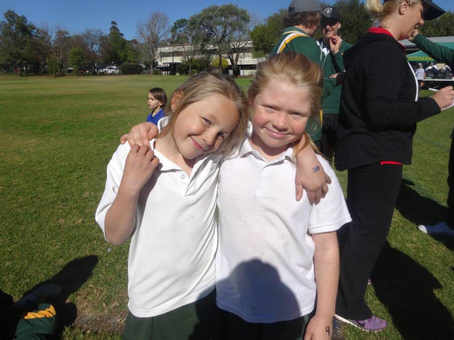 GREAT MATES: Emily Davis and Millie Rumbel take a break during the Public School carnival.