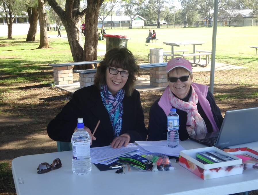 Gunnedah Public School staff Jenny Wales and Marg Kersley busy recording sporting results at the recent athletics carnival.