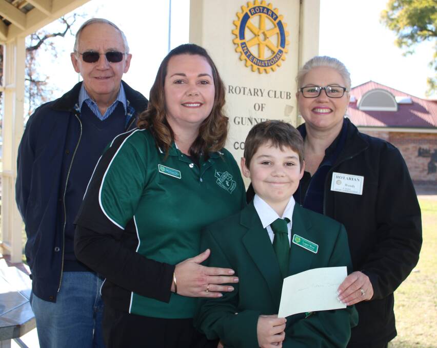 COMMUNITY SUPPORT: Curlewis Public School P&C president Casey West receives a donation from Rotary's Roger Lucas (left) and Wendy Marsh (right). Captain Logan West is also pictured.