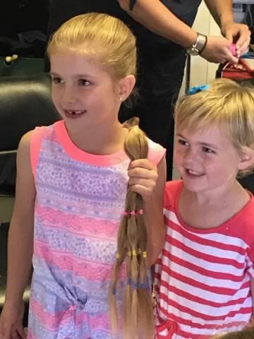 Marnee shows off the impressive length of her hair after it was cut.