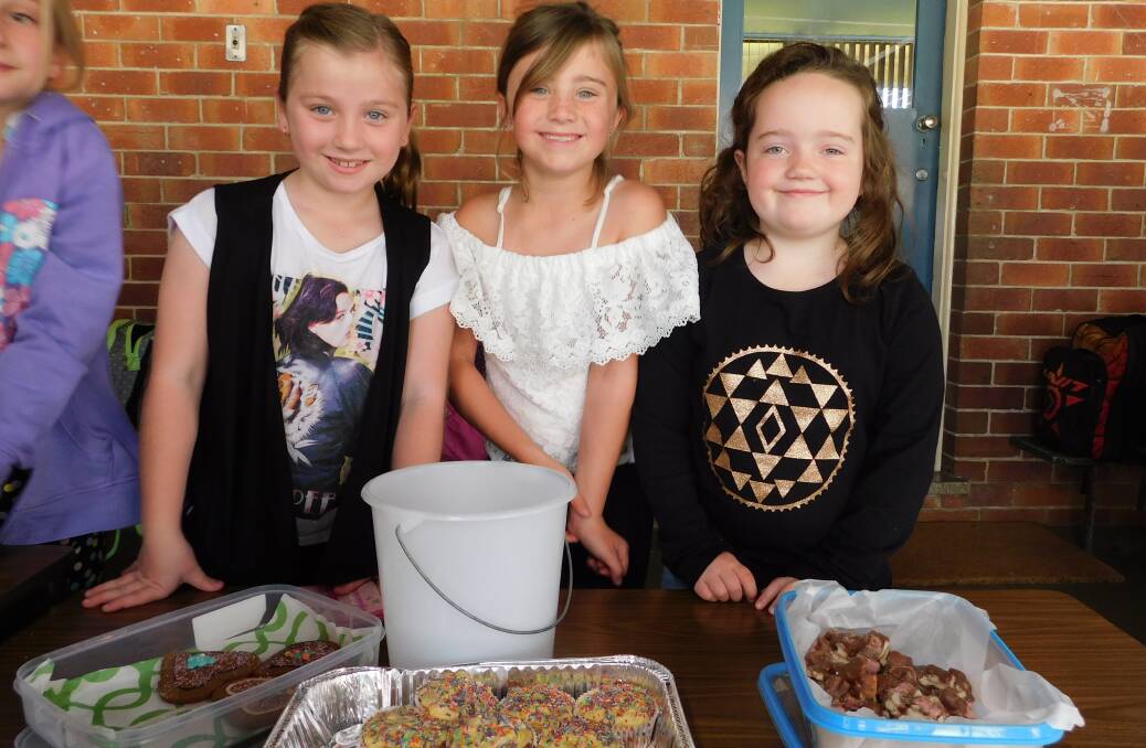 St Xavier's Primary School students Brooke Kiehne, Ally Davis and Georgia Kirby raise funds for Catholic Missions through a cake stall.