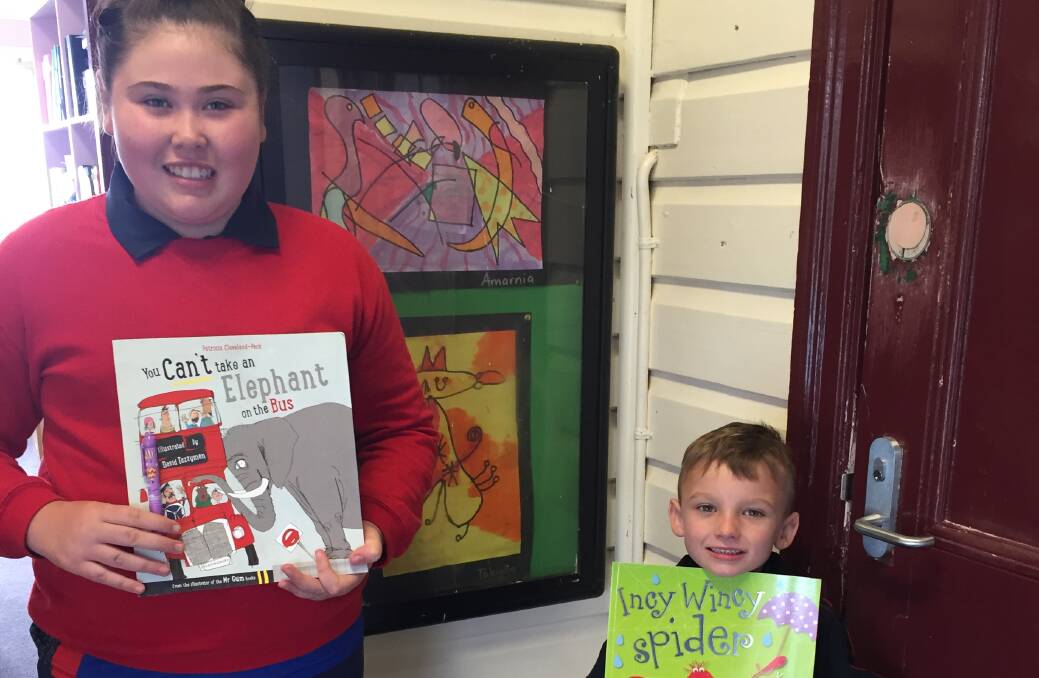 Carroll Public School's Smiley Face winners Amarnia Elphick and Preston Wheeler with their book prizes.