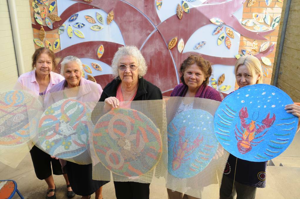 Janet Wanless, Shirley Long, June Cox, Gloria Foley and Alyson Cox in 2016 with some of the 32 round mosaic tiles that will be part of the feature.