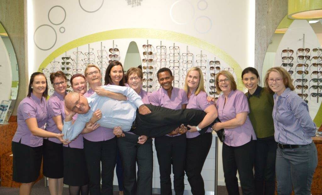 Optometrist Tim Duffy with the numerous staff at his Gunnedah practice.