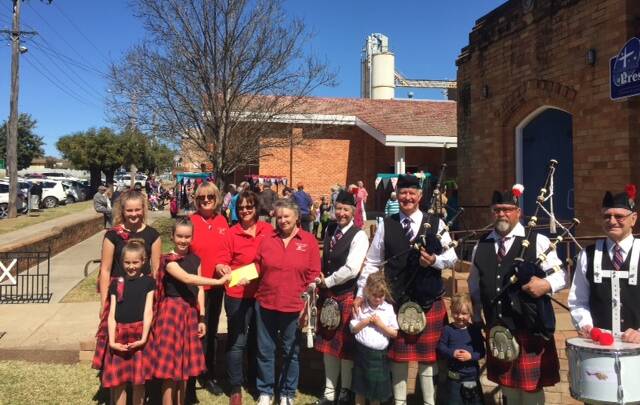 DONATION: Plains, Pipes and Drums hand over a cheque for $1600 to Westpac Rescue Helicopter Service. Photo: Supplied