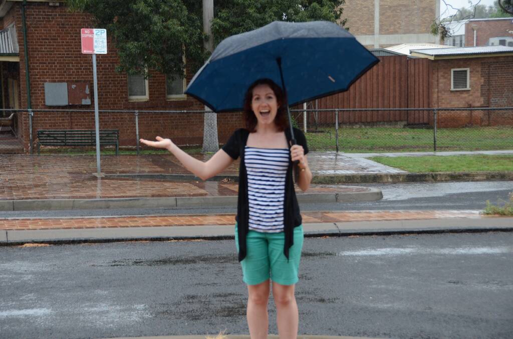 MAKING A SPLASH: NVI journalist Vanessa Hohnke enjoys the Friday morning rain in Gunnedah. 