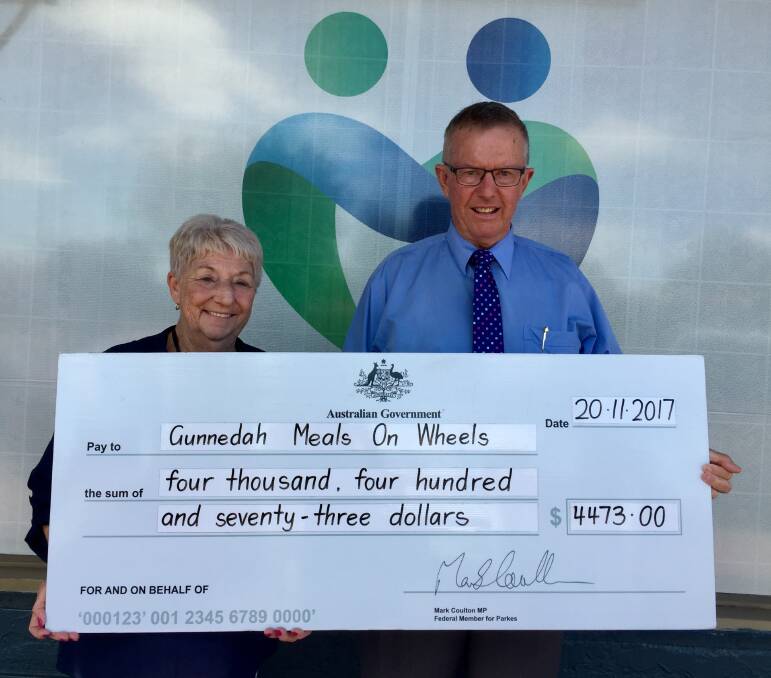 HELPING HAND: Colleen Fuller receives a grant for equipment upgrades on behalf of the Gunnedah Meals on Wheels Association from Parkes MP Mark Coulton. Photo: Supplied 
