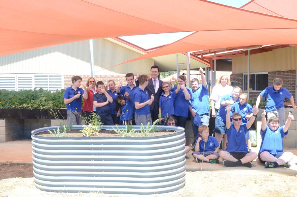 GREEN THUMBS: Students and teachers from GS Kidd Memorial School with Shenhua Chief Finicial Officer Lu Yang at the official opening of the school's sensory garden. Photo: Billy Jupp