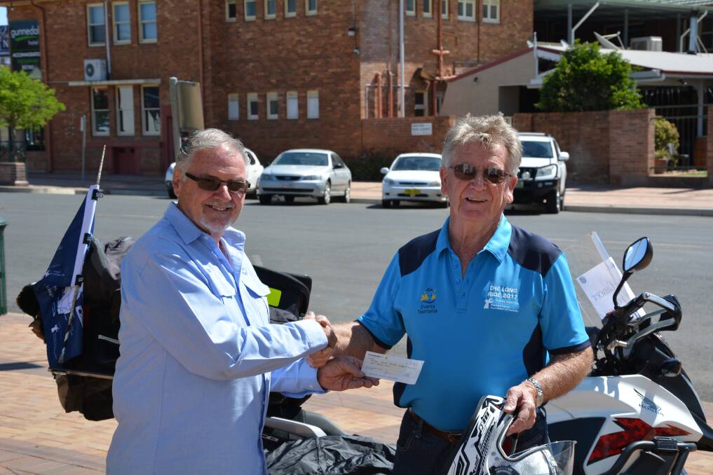 LONG RIDE AHEAD: Gunnedah Lions Club member Nev Adams presents Des O'Callaghan with a donation for $1000 to support The Long Ride.