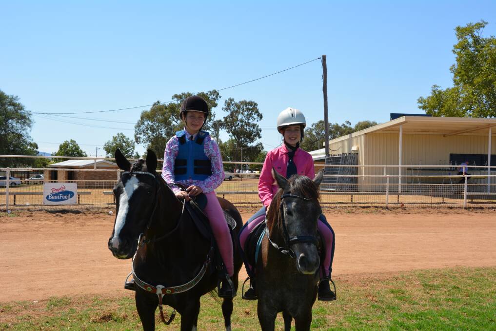 HORSE PLAY: Joslyn Bard and Sahara Peters enjoy the Gunnedah Pony Club's school holiday camp.
