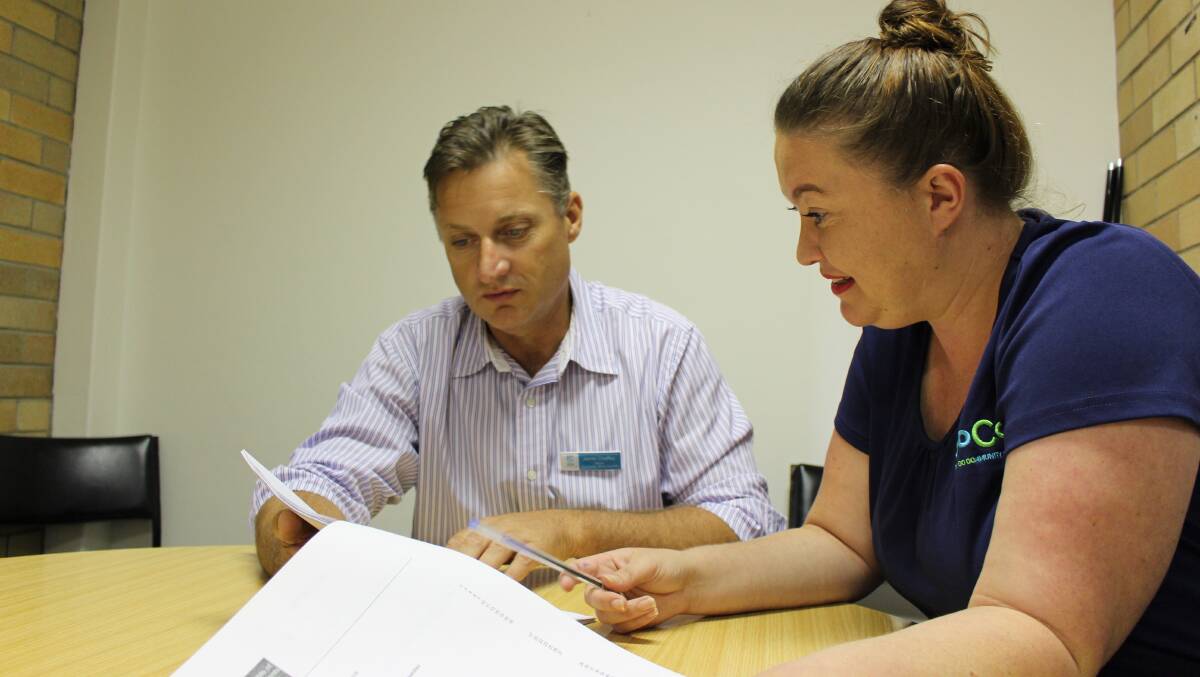Draft ready: Gunnedah mayor Jamie Chaffey and GoCo Community Hub representative Kate Mackley look over Disability Inclusion Action Plan notes earlier this year.