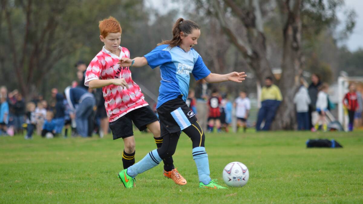 ON THE BALL: Claire McGuirk (right) from the Petries Mitre 10 side takes possession from Imperials player Carter McIlveen during last weekend's junior soccer in Gunnedah. Photo courtesy Sharon Tydd.