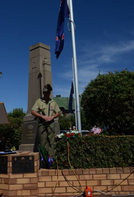 A defence member stands guard during Gunnedah's Anzac Day service.