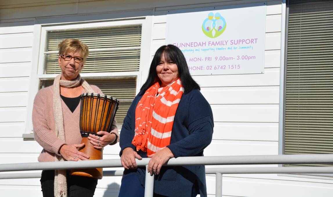 Get rhythm: Family support workers Judy Cavanagh and Karen Worboys have got the drums out to beat some positive change into family services programs. Photo: Chris Bath