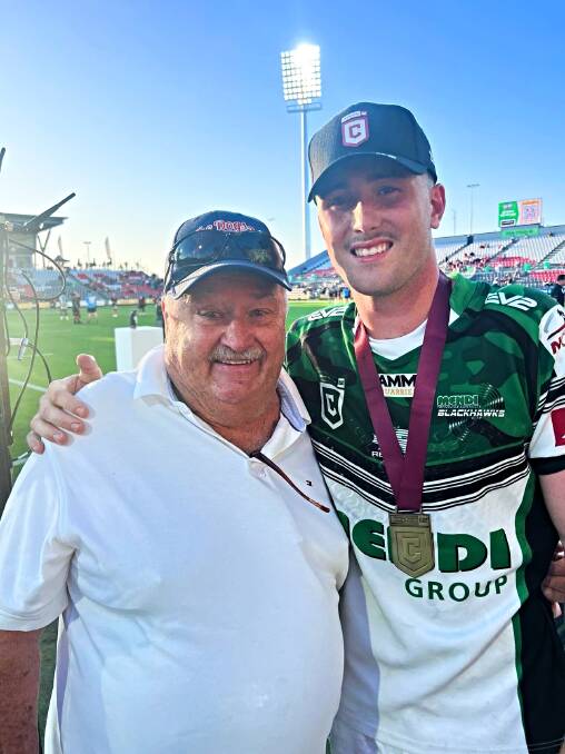 Kurt Fisher and his grandfather, Brian Lenton, celebrate the Blackhawks' Hastings Deering Colts grand final win. Picture supplied