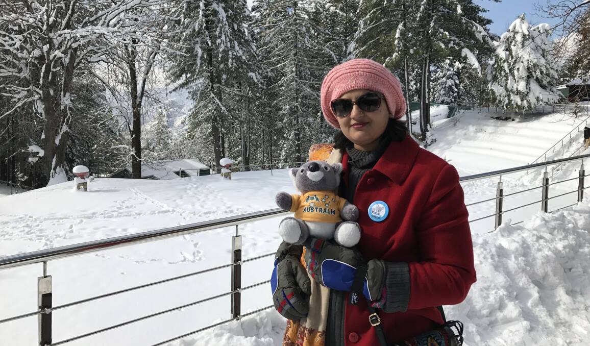 Snowy scenes: Dr Nadia Habib with a koala and her Gunnedah's Project Koala badge in Northern Pakistan during a recent visit.