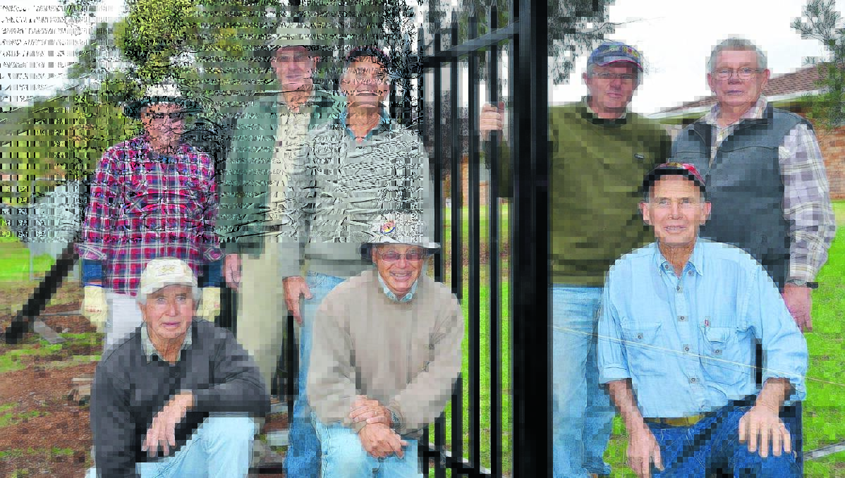 HOP TO IT: Gunnedah West Rotary Club members help erect a fence at Village Homes to provide security and keep unwanted roos out. 
