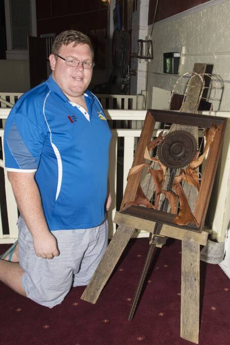 ON SHOW: Community events coordinator Angus Fraser with one of the winning artworks at the Sunflower Arts Festival. Photo: Peter Hardin