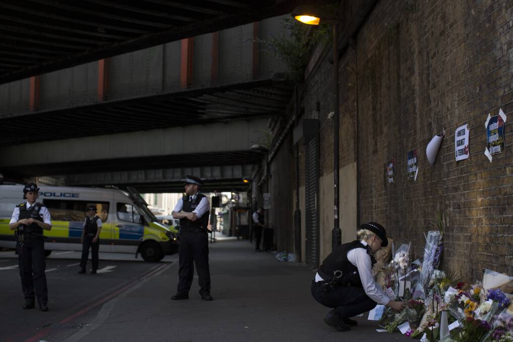 HORROR: A policewoman lays flowers ahead of a vigil outside Finsbury Park Mosque after an attack that left one dead and others injured. Photo: Dan Kitwood | Getty Images