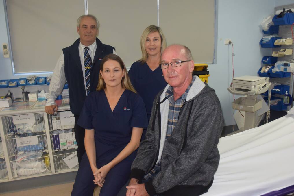 Tony Wilson (far right) owes his life to hospital manager Tony Roberts, nurses Kim Beerman (at front) and Stacey Butler and other team members for their quick action.