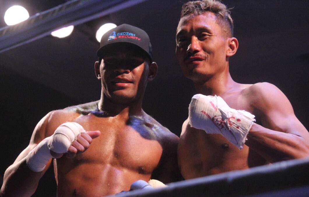 Silisia and his opponent, Indonesia's Bima Prakosa, share a nice moment after the latter was knocked out in shocking fashion. Picture by Zac Lowe.