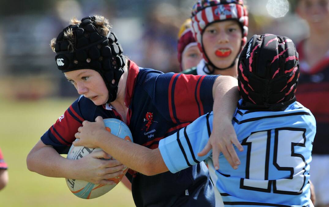 Strength: Gunnedah U12s player Sam Sawyer looks to push through this tackle during Sunday's Gunnedah Junior Rugby Carnival. Photo: Paul Mathews