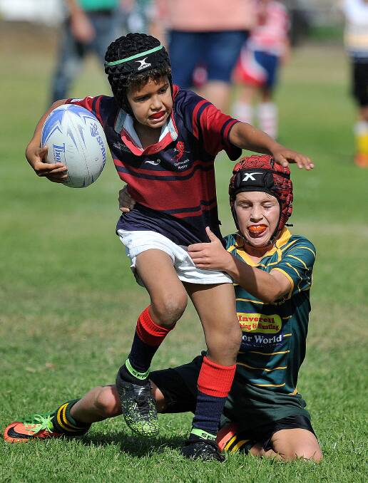 Powerful: Eddie Waerea looks to step out of this tackle playing for the Gunnedah U8s against Inverell at Sunday's carnival. Photo: Paul Mathews