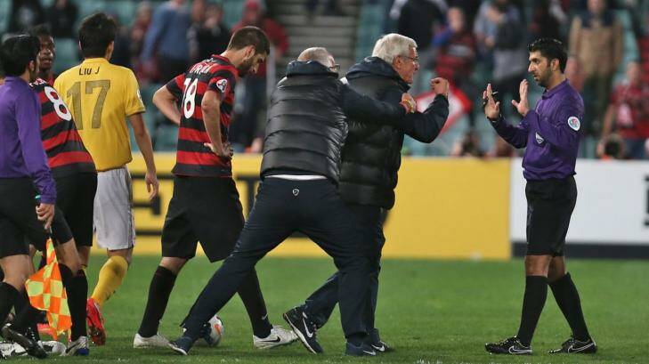 Chaos reigns: Marcello Lippi approaches the referee after his Guangzhou Evergrande side had two late red cards in the 1-0 Asian Champions League loss to Western Sydney. Photo: Brendan Esposito